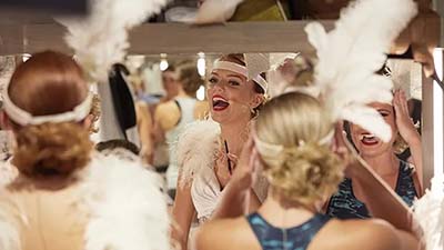 People in 1920s feathered fancy dress