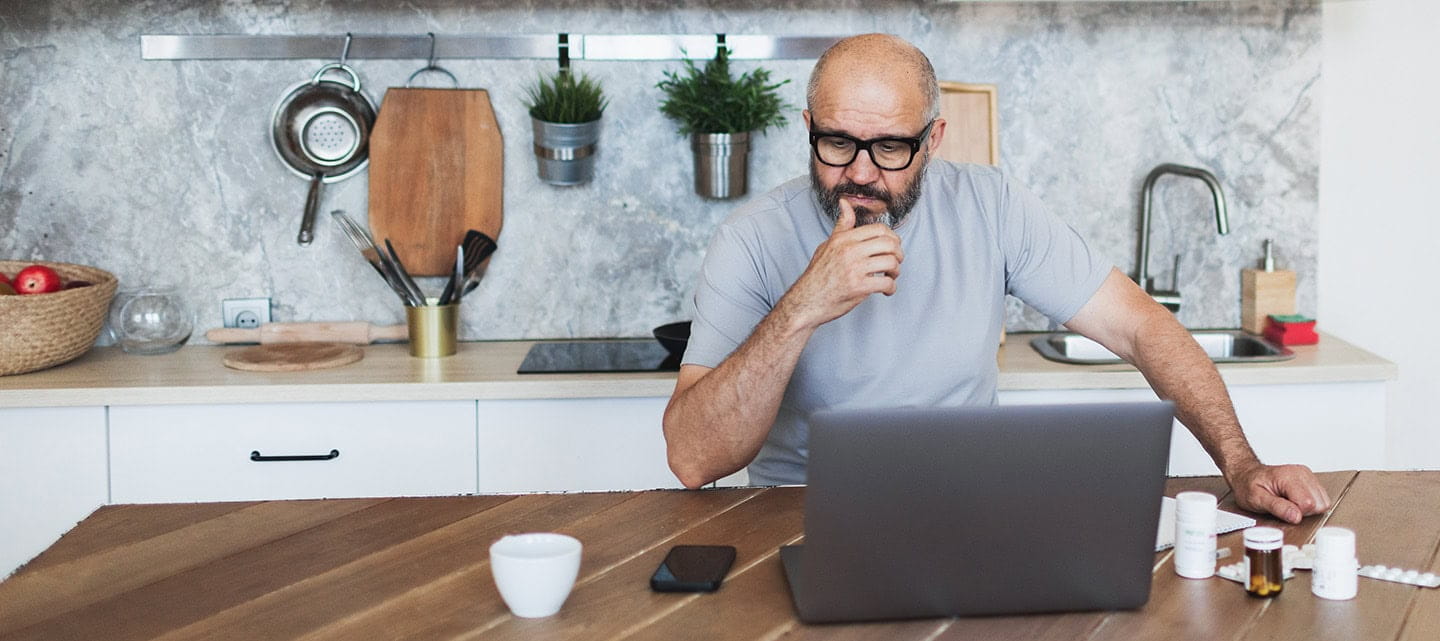 Mature adult man consulting with doctor using laptop