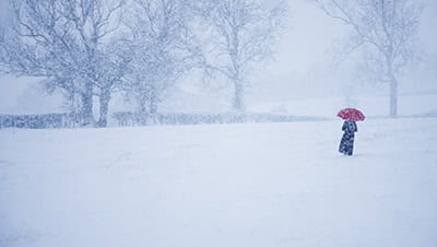 A person walking through a snow storm 