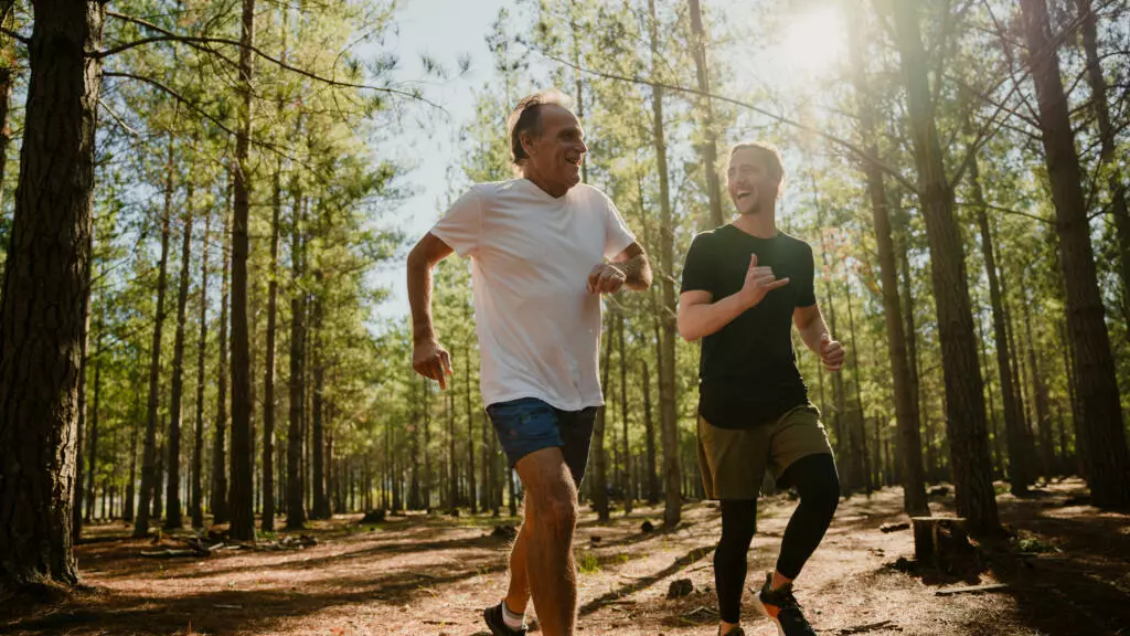 Two people running in a forest