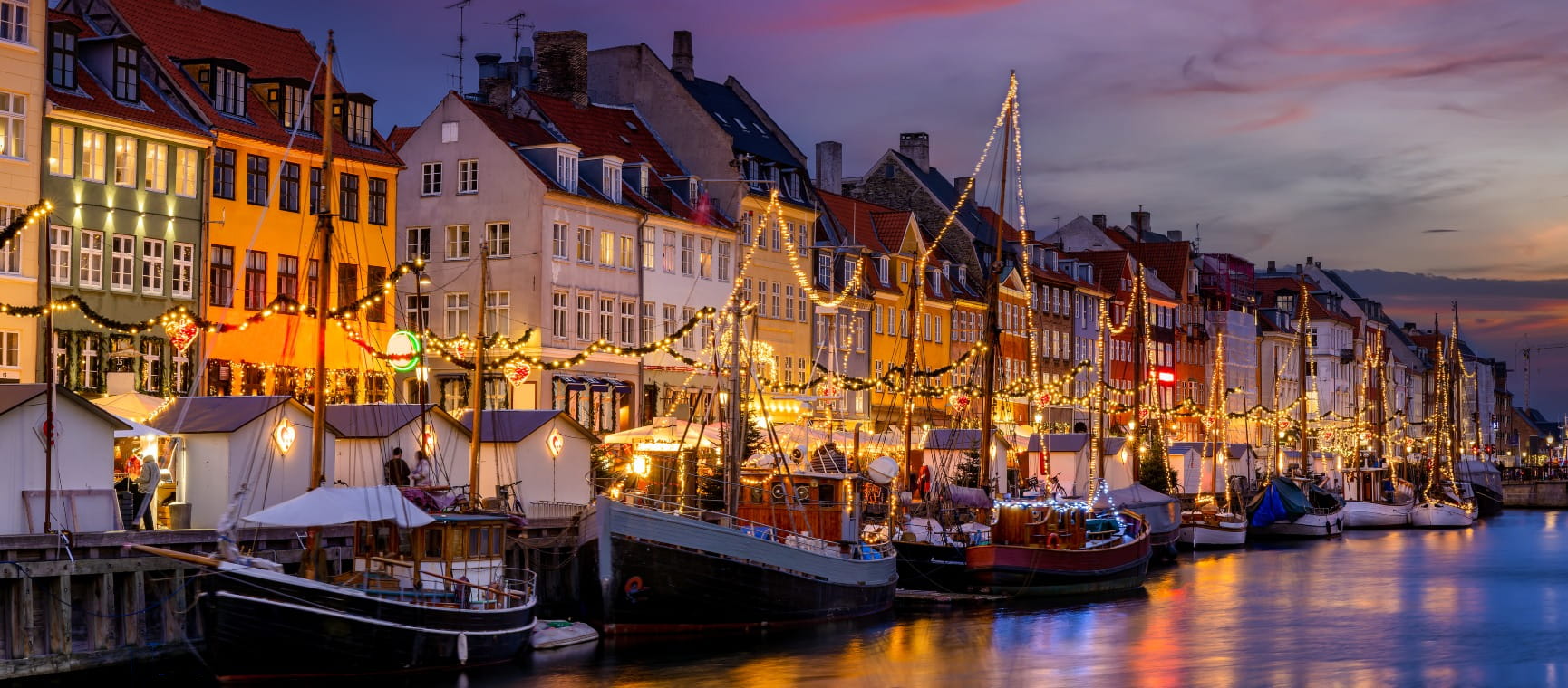 Winter sunset view of the Nyhavn area at Copenhagen, Denmark, decorated for Christmas