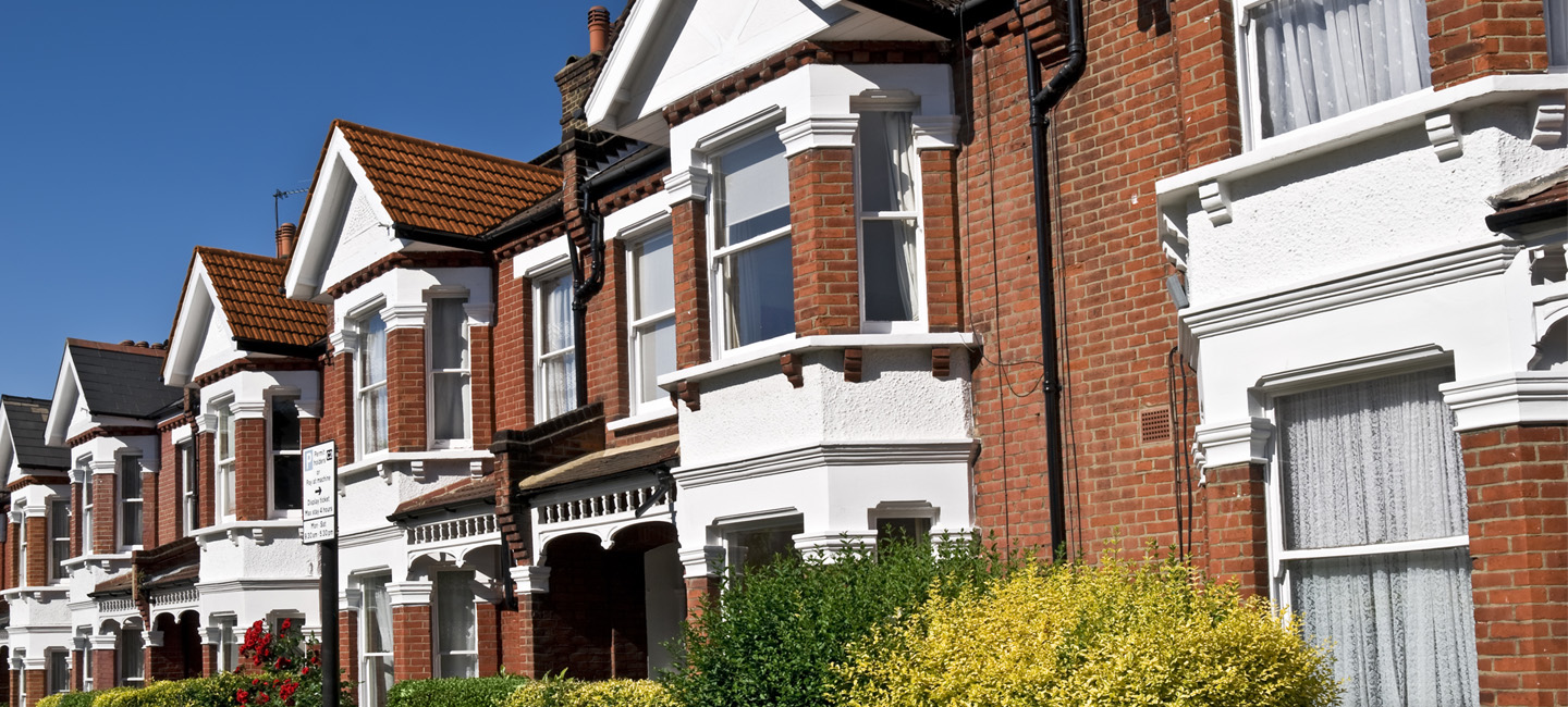 A row of houses on a blue sky day