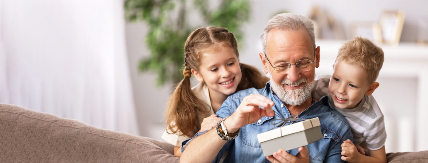 A grandfather with his grandchildren at home